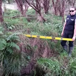 Jeanette using a level to measure the bank slope